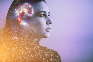 A double exposure image of a woman's profile shows a galaxy and clusters of stars overlaid on her head, symbolizing imaginative, intelligent, and cosmic thoughts. The background is a soft gradient of purple and blue hues.