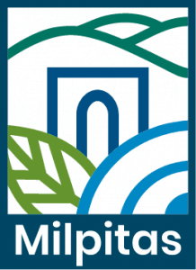 Logo of Milpitas featuring stylized blue and green shapes representing hills, a leaf, and a central arch, with the word "Milpitas" written below in green letters.