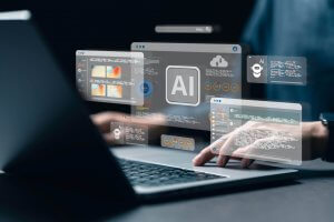 A person types on a laptop as virtual screens display AI icons, graphs, and code projected above the keyboard, symbolizing AI development and data analysis.