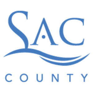 Blue logo with the text "SAC COUNTY" in stylized letters, with a dot in the center of the letter "A" and two wavy lines underneath "SAC," suggesting water.