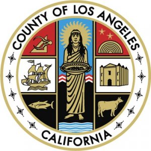 The official seal of Los Angeles County, California, featuring a central female figure with symbols including a ship, a cow, a fish, a building, a rainbow, and a tool, encircled by the county and state name.