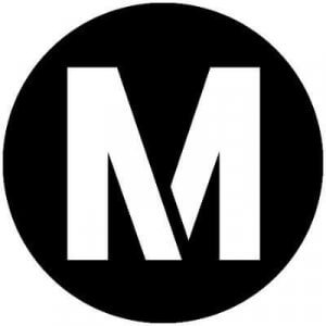 A bold, white letter "M" is centered inside a solid black circle on a plain white background.