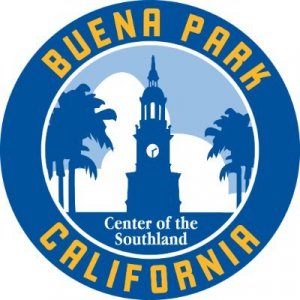 Circular logo for Buena Park, California. It features a clock tower, palm trees, and white clouds with the words "Center of the Southland" in the center. "Buena Park California" is written around the border in yellow letters.