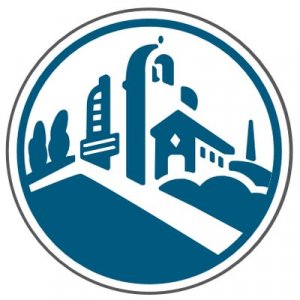 A blue and white circular logo featuring stylized buildings, trees, and a sloped landscape, suggesting an urban or community setting.