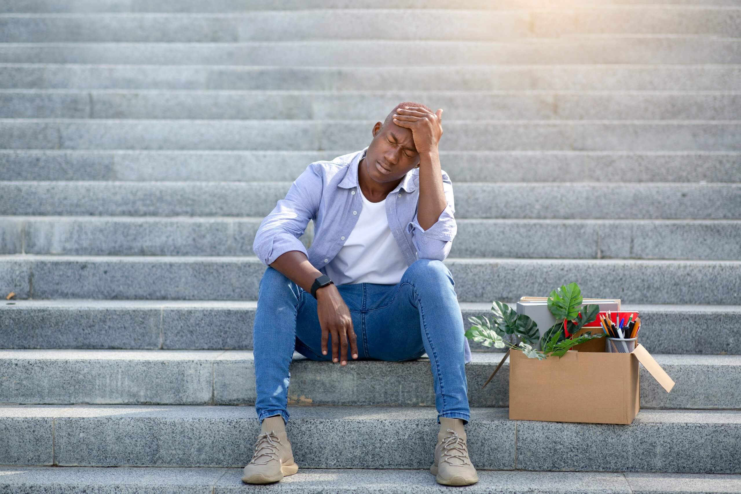 Depressed,Black,Guy,With,Personal,Belongings,Sitting,On,Stairs,After