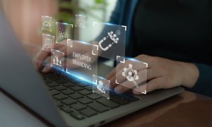 A person typing on a laptop with floating digital icons related to employer branding, including graphics of people, magnets, and gear symbols, representing concepts like talent recruitment and business strategy.