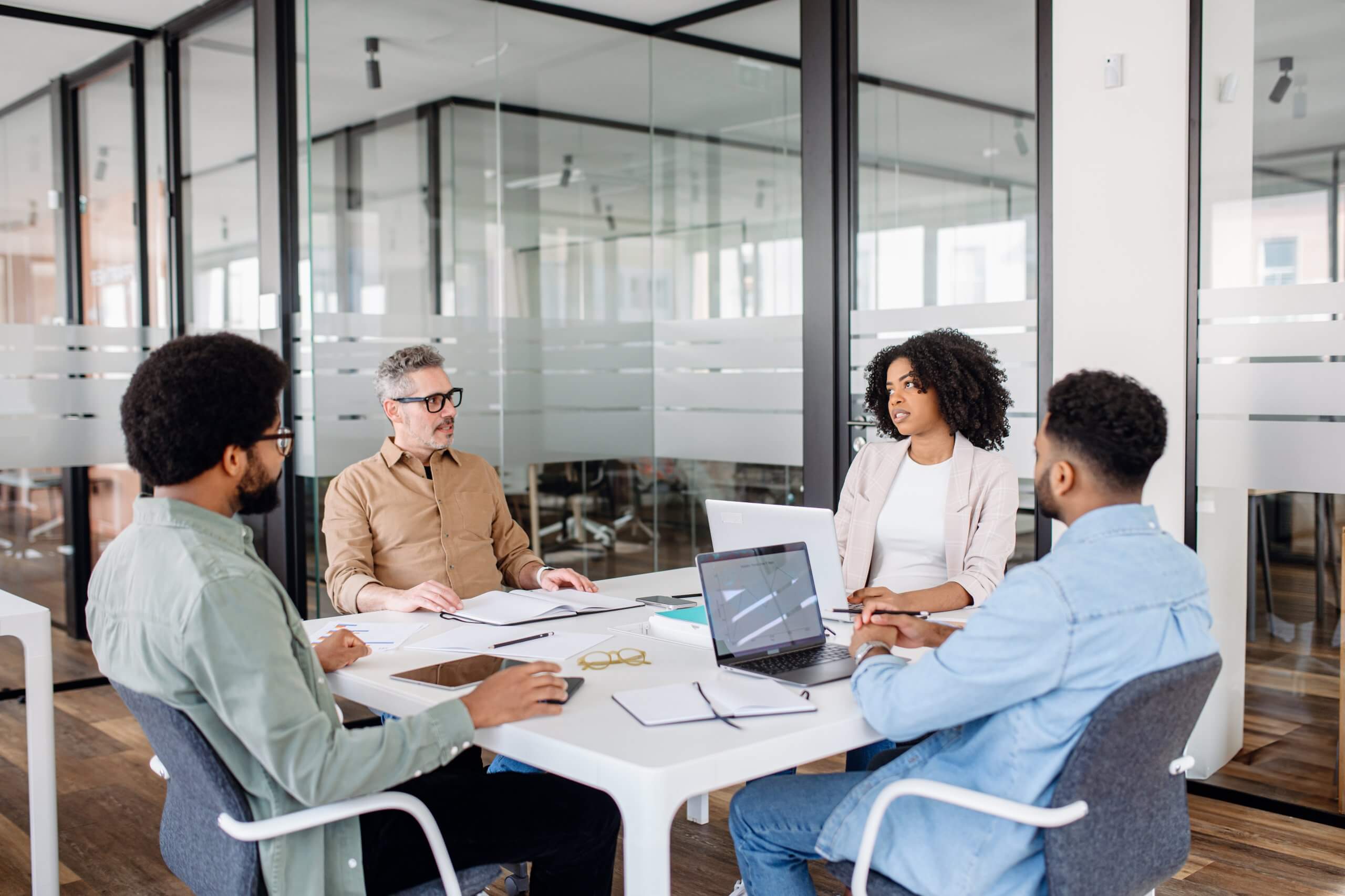 A red and blue horseshoe magnet attracts wooden blocks with male and female business icons, linked by white lines, symbolizing attracting top talent or networking.