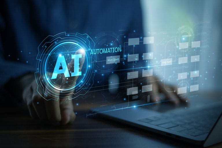 A person uses a laptop with a holographic interface displaying the words "AI," "Automation," and digital icons, symbolizing leadership in artificial intelligence and automation technology.