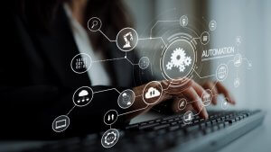 A person typing on a keyboard with digital icons, AI elements, and gears representing automation, technology, and process flow overlaid, conveying the concept of business automation and digital transformation.