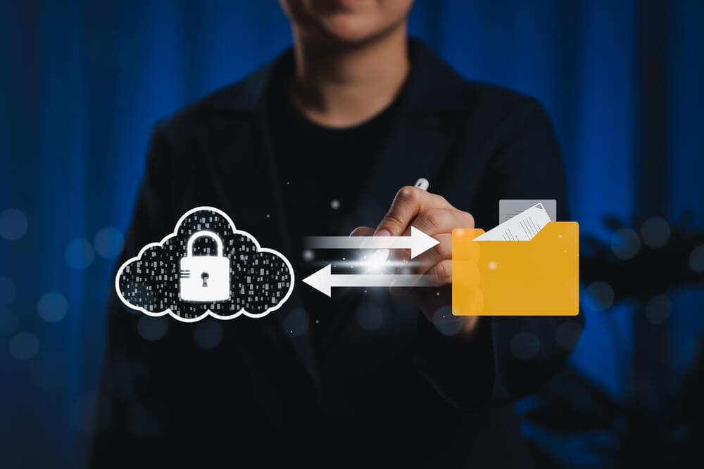 Cloud,Security,And,Document,Management,System,(dms),Concept.,Person,Using A human hand writes on paper while a robot hand types on a laptop keyboard, separated by the screen, symbolizing collaboration between government workers and artificial intelligence.