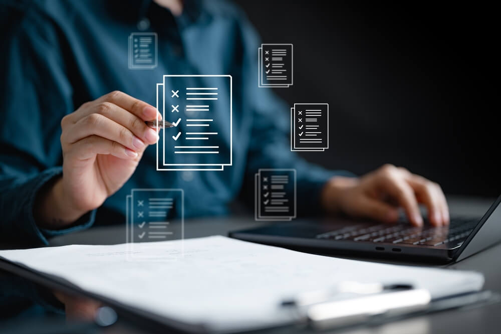 Document,Management,Checklist.,Check,Mark,Approved.,Audit,Certificate,Evaluate,Examination A person in a suit lifts a wire cage off a small figurine dressed in business attire, symbolizing freedom or release from confinement in the context of recruitment, on a white surface.